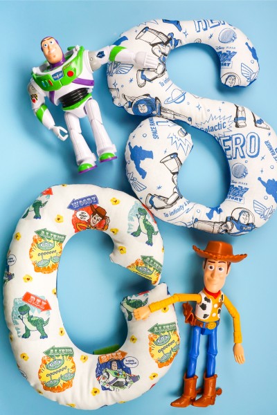 The Buzz Lightyear and Woody characters from Toy Story with alphabet stuffies make by the Cricut Maker