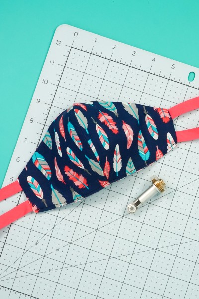 Make sewing a fitted mask pattern easier by cutting in your Cricut Maker! Get the free SVG to make this easy-to-sew fitted mask with ties or elastic.