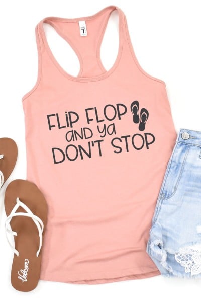 Blue jean shorts, white sandals and a pinkish colored tank top that says Flip Flop and Ya Don't Stop