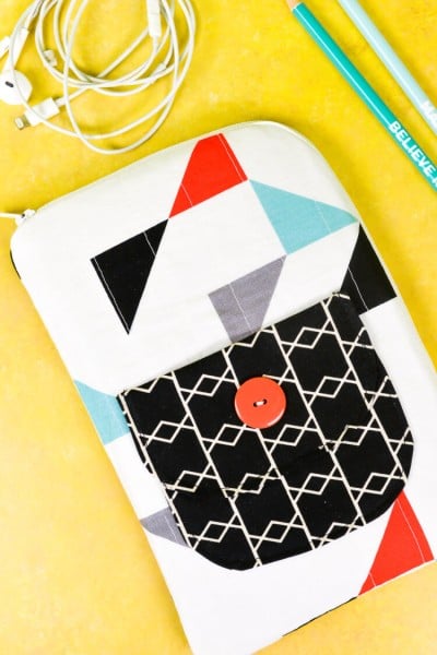 Two pencils, a charging cord and a decorated tablet case