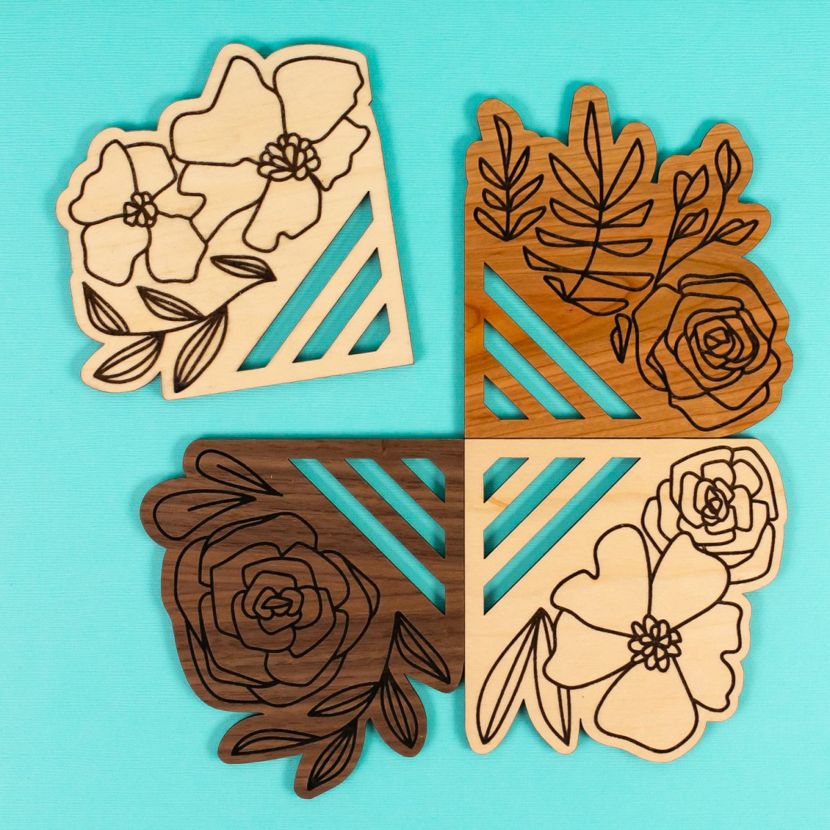 Laser cut coasters on a teal background