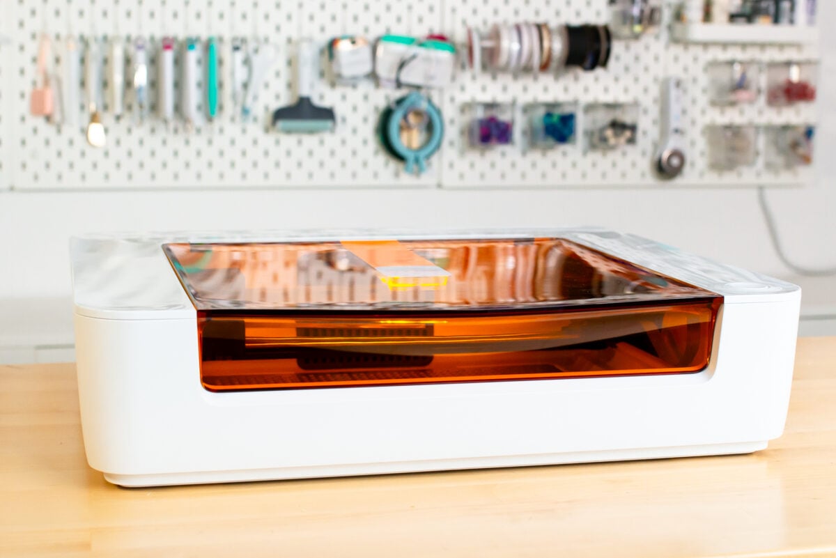 Glowforge Spark on craft table with craft supplies in the background