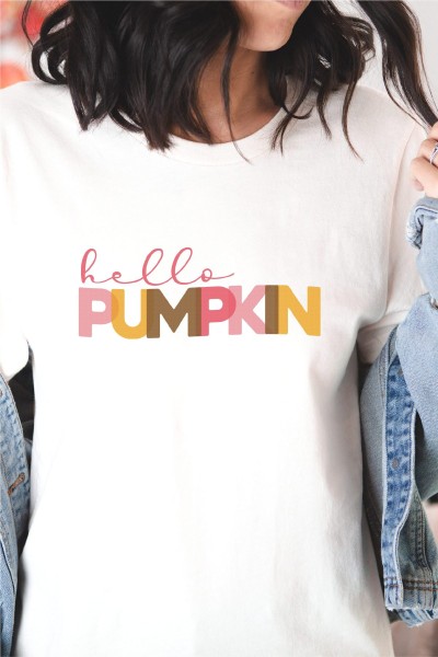 Woman wearing a denim jacket and a white t-shirt that says Hello Pumpkin
