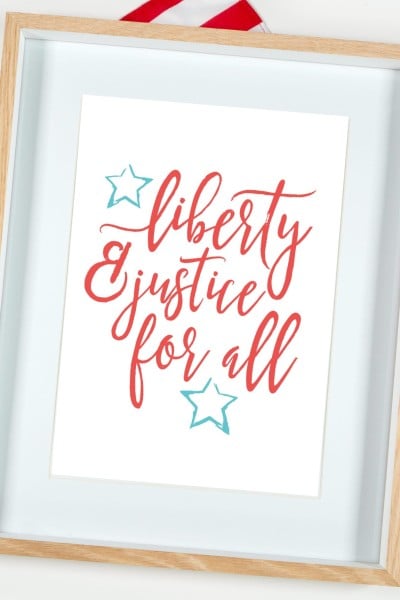 Liberty and Justice for All quote framed with American flag.