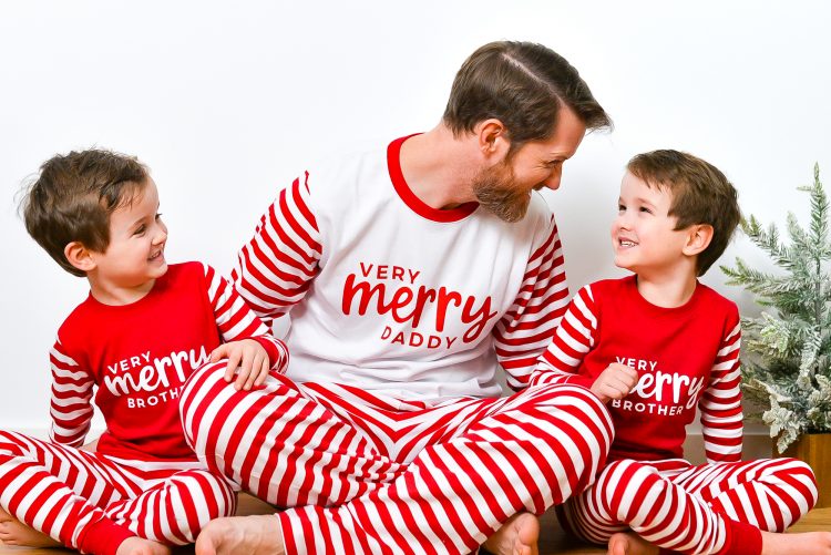 Boys wearing Very Merry Brother shirts and dad wearing Very Merry Daddy shirt