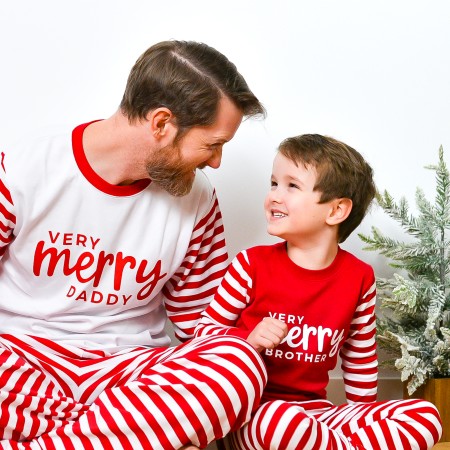 Boys wearing Very Merry Brother shirts and dad wearing Very Merry Daddy shirt