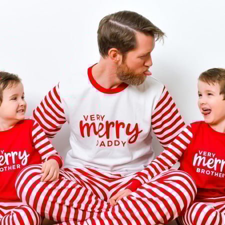 Boys wearing Very Merry Brother shirts and dad wearing Very Merry Daddy shirt