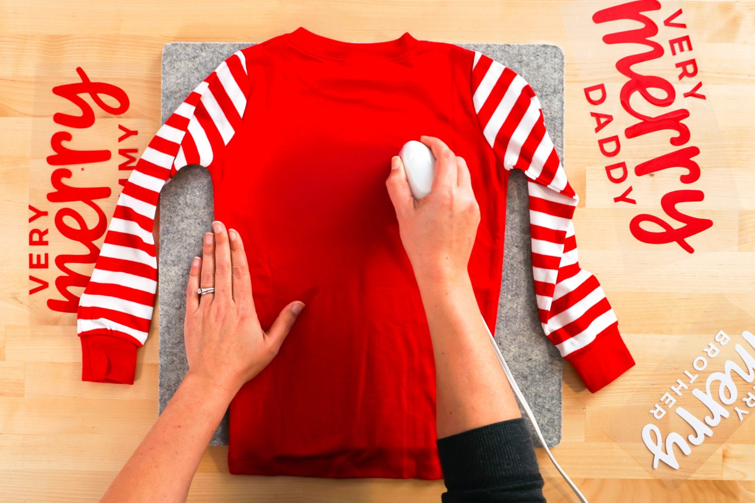 Hands ironing the back of the christmas pajamas