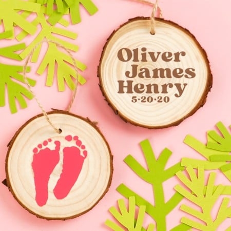 Use your Cricut Explore, Cricut Maker, or Cricut Joy to easily cut your newborn’s footprints out of iron on vinyl (HTV) and make sweet keepsake footprint ornaments.