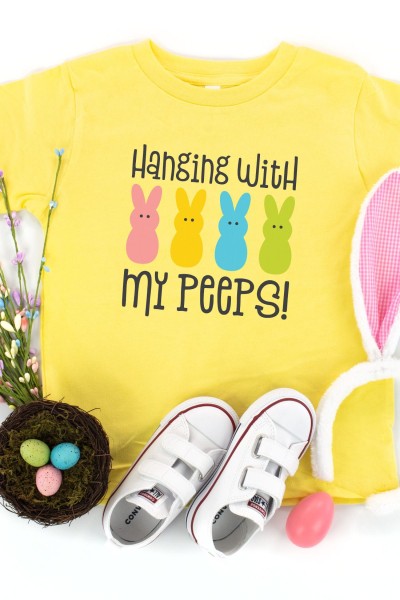 Yellow t-shirt with 4 bunnies on it and the saying Hanging with my Peeps