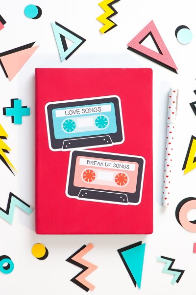 Pink notebook with big mix tape sticker, surrounded by 80's shapes