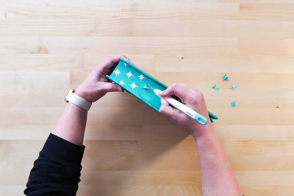 hands removing vinyl from book