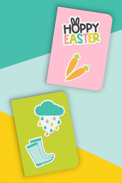 A pink and a green notebook each with Spring and Easter stickers on them