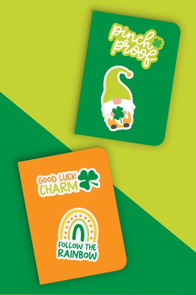 St. Patrick's Day stickers on a green and on an orange notebook