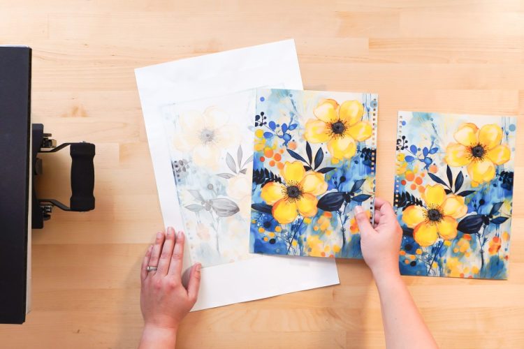 Hand holding journal cover next to sublimation design