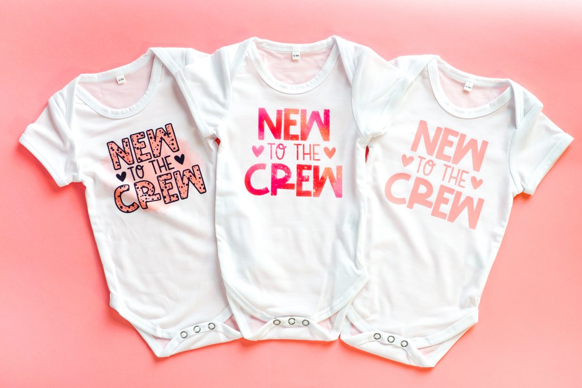 Three onesies with "new to the crew": sublimation, infusible ink, htv