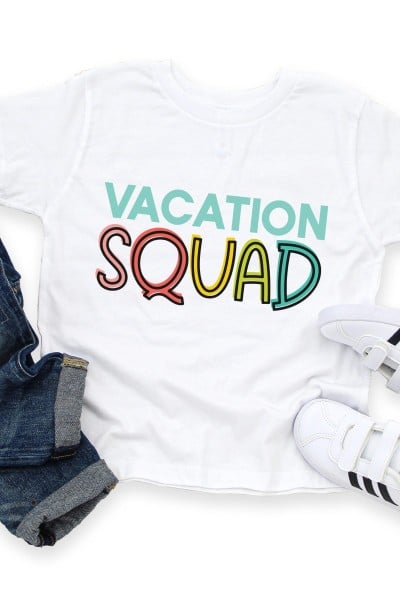 Blue jeans, white tennis shoes and a white t-shirt that says Vacation Squad