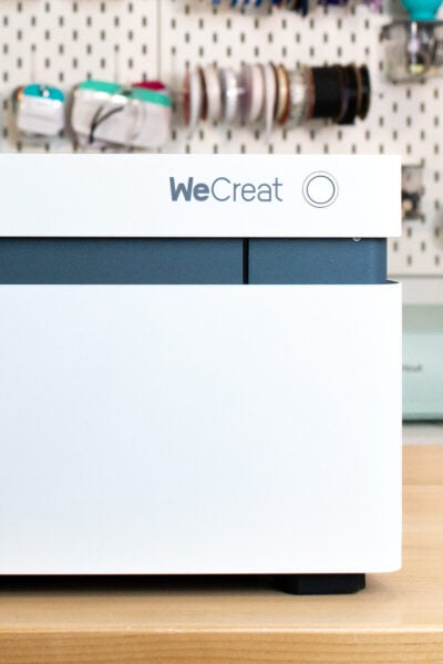 WeCreat Vision laser on a table with crafty pegboard behind