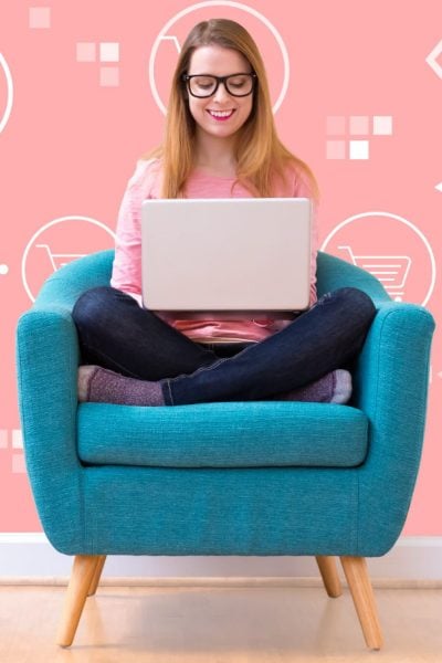 Woman sitting in chair holding a laptop