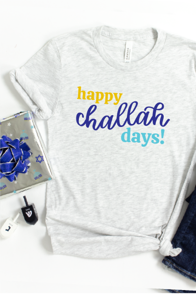 Blue jeans, and gray t-shirt with the saying, Happy Challah Days!