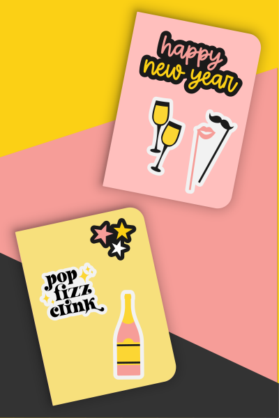 A yellow and a pink notebook with New Year's Eve stickers on them